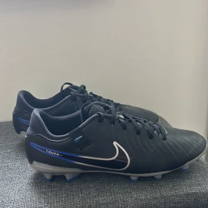 Nike Tiempo Legend 10 Elite AG-PRO Shadow - Svart/Krom/Blå - Nike fotbollsskor i färgen svart/krom/blå, storlek 44.5. Vi kör på 500 kr med tanke på att dom är inte så använda och är i bra skick, kan gå ner till 400 max. Fraktar ej, helst mötas upp eller så funkar det att komma och hämta dem👍🏽 
