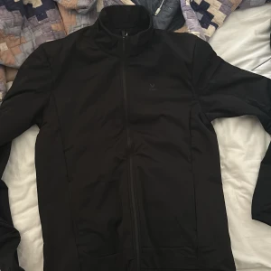 Svart soc träningskofta  - En svart soc träningskofta som är helt oanvänd och vill bli av med så snabbt som möjligt, storlek M. Vi kör på 100 kr för koftan just för att jag vill bli av med den.