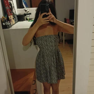 Blommig kort klänning  - Superfin svart och vit klänning med ett sött blommigt mönster. Den är i bra skick och är hyfsat stretching.