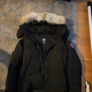 En svart wyndhamer från Canada gose  - En svart Canada gose Wyndhamer,den är helt oanvänd.det är en red leabel,själva jackan är på alla sätt bra och högsta kvaliten.jag vill sälja den eftersom den var lite stor på mig.