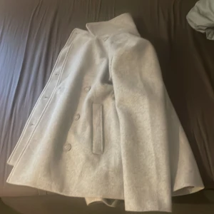 Grå kappa från Zink - 250 kr + frakt.  Säljer en grå kappa från Zink i storlek S (36/38). Den har en klassisk design med knappar framtill och är perfekt för höst och vår. Kappan är i bra skick och har en snygg passform som passar till många olika outfits. Kan postas