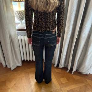 Lågmidjade bootcut jeans med silvrig tråd på rumpan innerbenslängd: 85 cm midjemått: 39 cm tvärs över