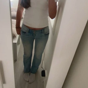 Lågmidjade Ljusblå jeans - Assnygga ljusblå jeans med en klassisk femficksdesign och knappgylf. Jeansen är lågmidjade och har en lätt tvättad look! Pris ge att diskutera💕💕