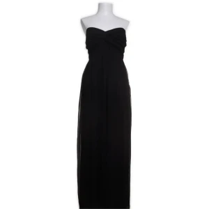 Svart axelbandslös långklänning - Elegant svart axelbandslös långklänning med en smickrande passform. Perfekt för en stilren och sofistikerad look. Klänningen har en enkel design som framhäver figuren.