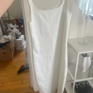 Vit klänning med slit där bak - Oanvänd från bikbok 