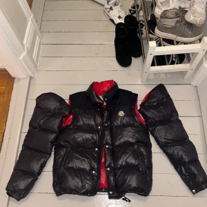 Moncler Andersen jacka/väst storlek 3 - Väldigt fin Moncler jacka/väst, avtagbara armar äkta såklart Den är köpt på vongreven closet ,skicket som angavs där var 8/10, skicket är detsamma som den köptes i. Minimala defekter men hindrar ej funktion. dm för fler bilder, Äkthetsbevis…storlek 3
