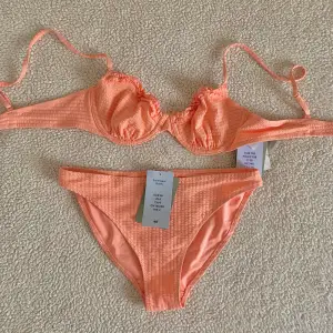 Bikini från H&M i aprikosfärg. Ny med tags kvar, utan anmärkningar. Storlek 75B i överdel och 36/S i underdel.
