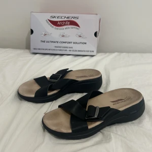 Skechers Go walk arch fit BBK svart, sandaler - Skechers go walk arch fit BBK svarta sandaler i fint skick (kommer med förpackningen), storlek 37, skor som köptes och låg bara kvar i hyllan, originalpris 1000 kr, mitt pris kan diskuteras!😊