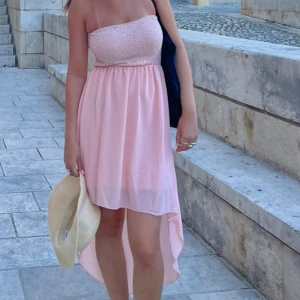 Rosa klänning  - Så fin somrig bandeau klänning! Rosa med spets mönster där uppe, har även inlägg vilket gör att den sitter på plats bättre!🤗🩷