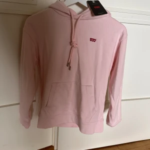 Hoodie  - Levis hoodie. Den är i storlek XXS och har en ljusrosa ton. Prislappen är kvar och den är aldrig andvänd - köpt för ca 8 månader sedan 🩷Köpt för 819kr och säljer för 700 