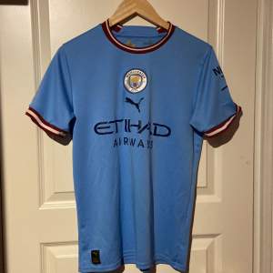 Säljer min feta man city fotbollströja då den är för liten. Den är i riktigt bra skick och köpt på unisport. Den är i storlek S men passar M. Tveka inte om att ställa frågor. Mitt pris 250kr