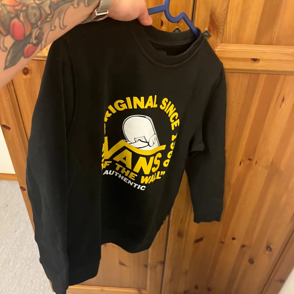 En svart långärmad tröja från Vans med texten 'The Original Since 1966' och 'Off The Wall' i gult. Tröjan har en rund halsringning och är tillverkad i ett bekvämt material. 10/10 skick som ny. Aldrig använd eftersom av en slump köpt Medum i dam. Liten i storleken mer som XS/S . men väldigt fet och sällsynt vanströja . Tröjor & Koftor.