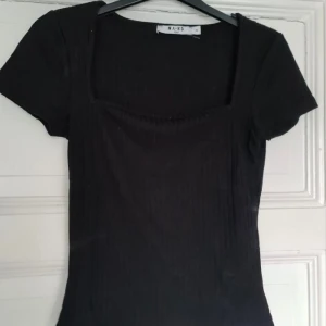 Ribbad svart topp - Ribbad svart topp från Nakd med fyrkants-urringning. Använd 1 gång. 