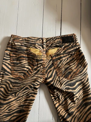 Lågmidjade zebrajeans - Unika jeans med zebramönster och mycket låg midja, straight i modellen! Storlek 27❤️ midjemått 38cm innerbenslängd 85cm