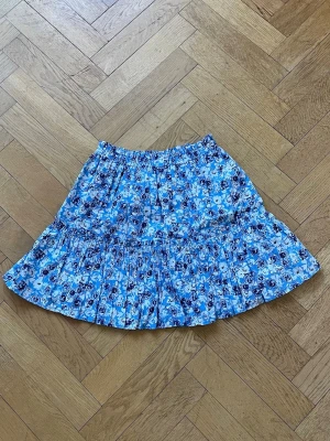 Blommig blå volangkjol - Supersöt kort blåblommig volang kjol