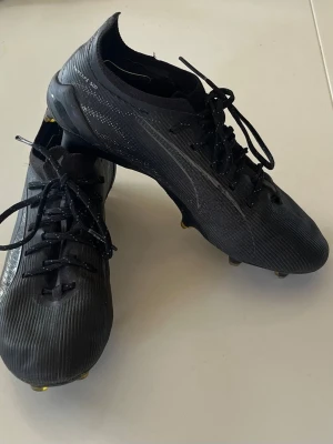Fotbollssko Puma Ultra svart strl 36 - Puma Ultra 5 Ultimate FG Fotbollssko, svart, strl 36, 22,5cm Gott skick. För spel på gräs.