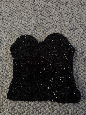 Svart glitter tubtopp - Säljer nu min glitter tubtopp från bikbok! Använda en gång💕
