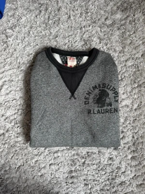 Denim Supply sweatshirt - Säljer en grå/mörkgrå sweatshirt från Polo Ralph Lauren Denim Supply. Den är i storlek medium. Den är väl använd men har inga defekter.  Skriv vid frågor👍