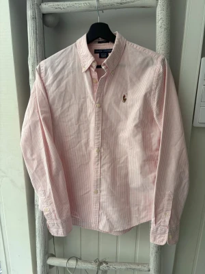 Ralph Lauren Skjorta Rosa/Vit Herr - Säljer nu min fina Ralph Lauren skjorta i Rosa/Vit färg! Skjortan är otroligt snygg, perfekt för sommaren! ✅Slim fit, storlek S, 100% Bomull✅❗️Inga defekter eller något liknande, otroligt gott skick!❗️ Fraktar alltid inom 24h. Skjortan är självklart äkta🔥✅