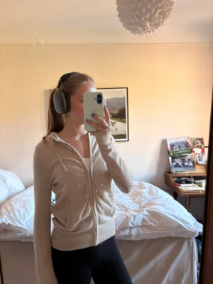 Soft goat hoodie  - Mysig beige hoodie med dragkedja och huva. Tröjan har ribbade muddar vid ärmslut och nederkant samt fickor framtill. Perfekt för en avslappnad och chill stil. Materialet ser ut att vara mjukt och stretchigt, troligen bomull eller bomullsblandning. 100%casmere