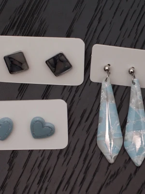 Handgjorda örhängen i polymerlera och stift i rostfritt stål ljusblå - Handgjorda örhängen i polymerlera och stift i rostfritt stål.  Självklart nya och oanvända. Storlek: Avlånga 1,5x5,5cm Stiftörhängen 1,5x1,5cm.  Färgerna kan variera beroende på skärminställningar.