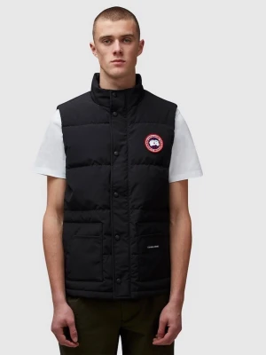 Svart dunväst från Canada Goose - Snygg svart dunväst från Canada Goose med klassisk logga på bröstet och hög krage. Västen har tryckknappar framtill och två stora fickor. Perfekt för lager-på-lager och håller dig varm under kyliga dagar.