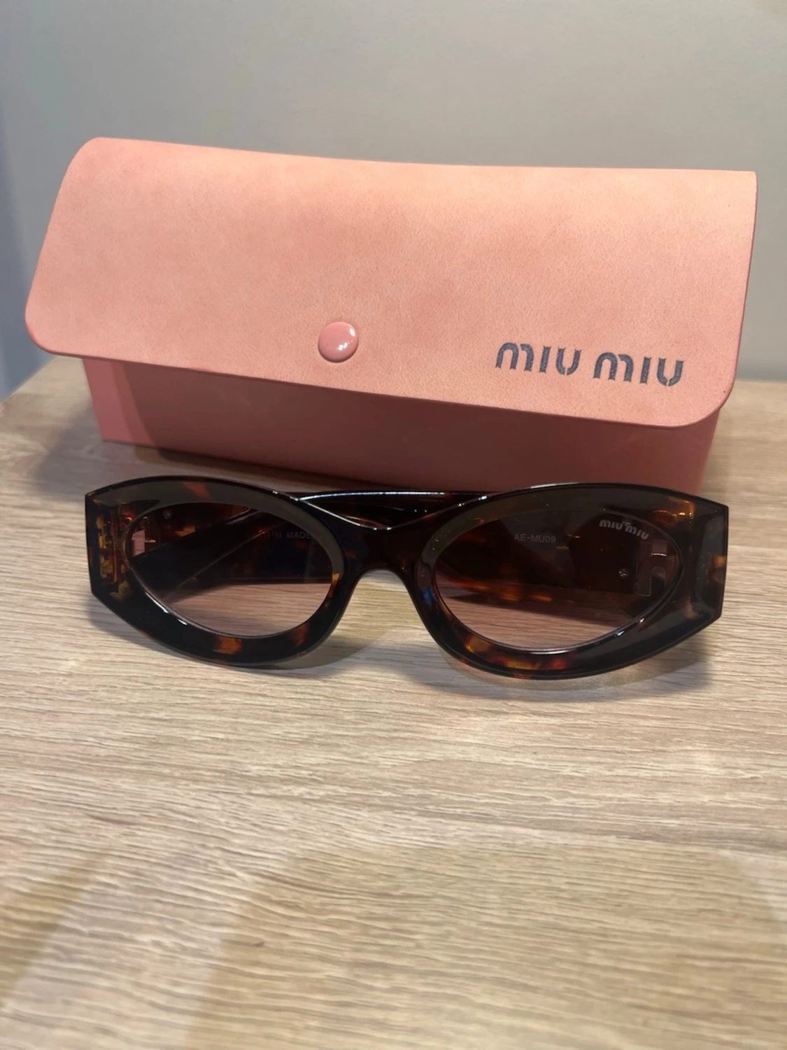 Bruna ovala solglasögon från Miu Miu