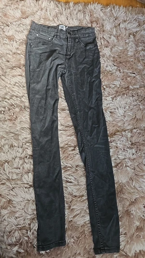 Svarta skinny jeans - Snygga svarta skinny jeans med klassisk femficksdesign och normal midja. Jeansen har dragkedjegylf och bälteshällor, perfekta till en avslappnad stil. Materialet är stretchigt för extra komfort och passform.