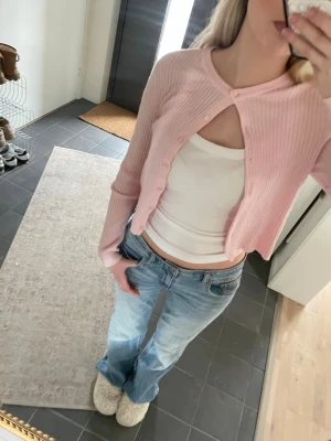 Ljusrosa ribbad kofta från lager 157 - Säljer en ljusrosa ribbad kofta från lager 157 i storlek S. Koftan har rund hals, långa ärmar och knappar framtill. Materialet är mjukt och stickat, perfekt för lager-på-lager. Enkel och clean design som är lätt att matcha med olika outfits. Bara använd en gång 💞