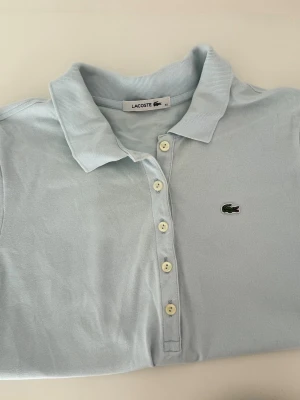 Light blue Lacoste polo  - Light blue Lacoste polo   Size: 42 (fits XS–S) Condition: used, in good condition  💰 Price: 150 kr  📦 Fast shipping / meet-up possible DM if interested 💌
