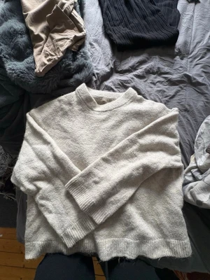 Stickad tröja från Gina Tricot - Mysig beige stickad tröja från Gina Tricot i storlek XS. Tröjan har en rak passform, ribbstickad rund halsringning samt ribbade muddar vid ärmslut och nederkant. Perfekt för lager-på-lager och chill dagar.