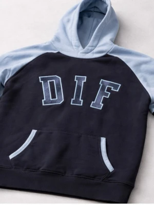  DIF hoodie - Snygg hoodie i svart med ljusblå huva och ärmar. Stor DIF-logga framtill i vitt och blått. Praktisk magficka med ljusblå detaljer. Perfekt för dig som vill representera laget med stil.