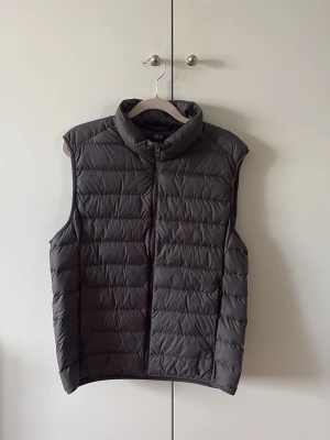 Grå Uniqlo Väst - Säljer nu min gråa väst från Uniqlo som är i ett grymt skick. Anledningen till att jag säljer är då jag växt ur västen och därmed aldrig använder den. 