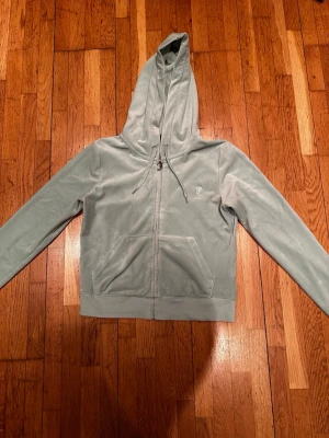 Mintgrön Juicy Couture Velour Hoodie – Storlek M - Superfin och klassisk zip-hoodie  från Juicy Couture i en jättefin mintgrön nyans. 