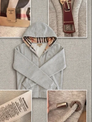 Burburry hoodie - Snygg grå hoodie med dragkedja och huva. Tröjan har dragsko i huvan, ribbade muddar och två fickor framtill. Perfekt för en avslappnad stil. Materialet ser ut att vara mjuk bomullsblandning.