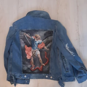 Handmålad distressed denim jean jacka,oversized - Oversized Jacka målad med oljefärg, målningen skildrar ängeln gabriel som dräper djävulen i form av en orm, en klassisk renaissance målning, jacka är oversized så den passar människor som vanligen bär 38,36 i dam storlek