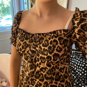 Leopardmönstrad klänning - Går att ha både offshoulder och uppe på axlarna! Endast använd 1 gång!