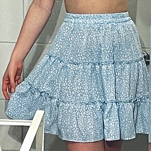 Minikjol från Shein 💙Storlek S💙 - SÄNKT PRIS!!!!❤️‍🔥Härlig ljusblå kjol med vita blommor. Supersöt och somrig! Går precis över knäna ( på mig iallafall som är 166 cm lång ). Bra material som är skönt och luftigt! Använd en gång och är i väldigt bra skick. Jag använder sällan kjol så därför säljer jag den. Säljs vid bra bud och frakt tillkommer😌💙