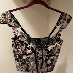 Corset - Victoria secret dream angel corset i svart med floral print. Kupan är 34D, och jag har storlek S på mina kläder. Helt oanvänd. säljs för 650kr ☺️ frakt ingår! 