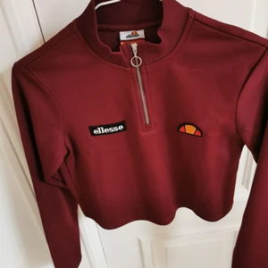 Croppad polo Ellesse - Vinröd kort polotröja med dragkedja från Ellesse. Nyskick. Storlek XS. Köparen står för frakten, kan även hämtas i Malmö! 