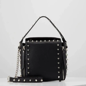 Svart väska med nitar - Säljer nu min slutsålda snygga zara liknade väska ifrån Missguided!💕Den är lite större ån zara väskan och alltså mer rymligt! Skicket är väldigt bra! Om många är intresserade blir det budgivning 🥰Direktpris 600 kr💕