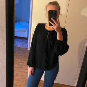 Svart blus HM strl 36 - Tre år gammal blus från HM, lite genomskinligt tyg, volang längst med framsidan🌹🖤