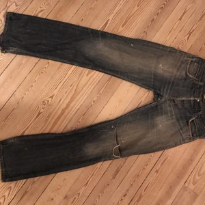 lågmidjade Lee jeans - Ett par snygg slitna Lee jeans. Dom har ett hål på vänster knä. Jag är 176 cm och dom är långa på mig❤️Dom är ganska stora i midgan, ❣️kan mötas i Stockholm köparen står för frakt annars ❣️