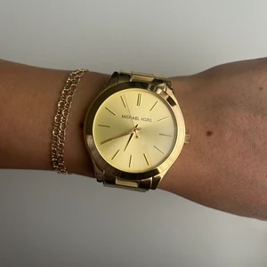 Michael Kors Klocka i Gulguldstonad stål - Michael Kors Klocka  - Runway Gulguldstonad/Gulguldtonat stål Ø42 mm. Använd en gång, ser ut som ny! Inga märken, ingenting. Kommer med förlängning av armband.