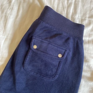 Juicy couture byxor  - Mörkblåa Juicy couture byxor i storlek xs. Bra skick men ena metallsaken på snörena har lossnat.