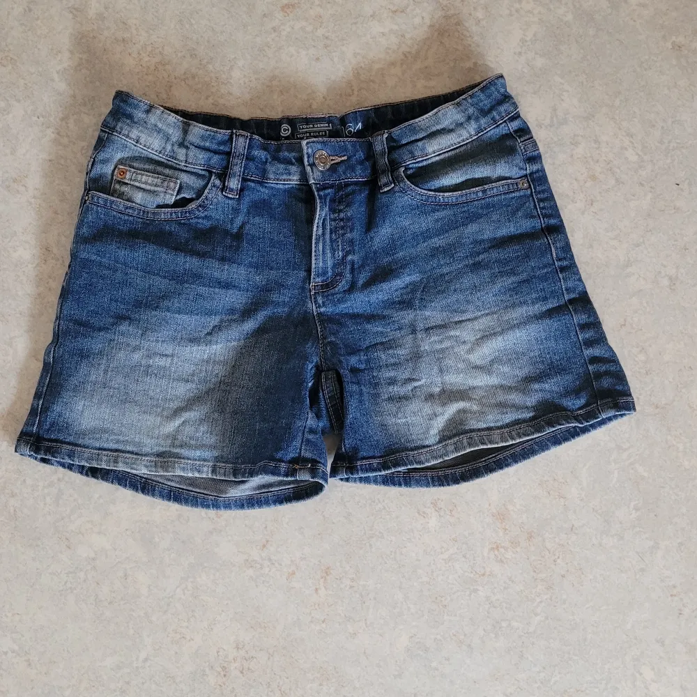 Blåa jeansshorts från Cubus i storlek 164. Fickor både fram och bak. Knapp och dragkedja i fram. 27 cm långa. . Shorts.