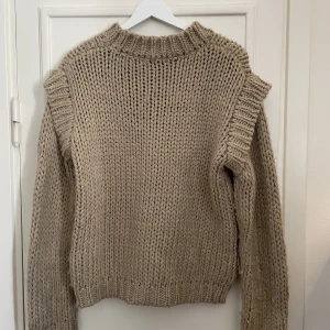 Grovstickad tröja  - Stickad tröja med bred krage samt markerade sömmar vid axlar. Perfekt inför hösten! 