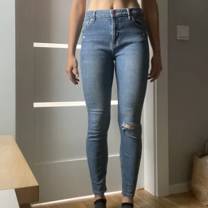 Denim jeans  - Blå jeans med rippat knä. Mid Waist.  Jag är 170 cm lång för referens. Använda ett fåtal gånger, ej slitna.  