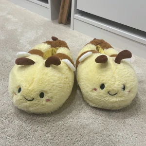 Tofflor  - Ett par SUPER gulliga humle tofflor, jätte varma och mysiga ganska slitna på botten, dom är tvättade i tvättmaskin! 🐝☺️