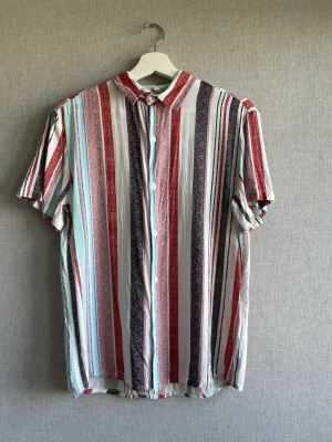 Skjorta  - Mångfärgad skjorta, gjord av polyester. Knappt använd 